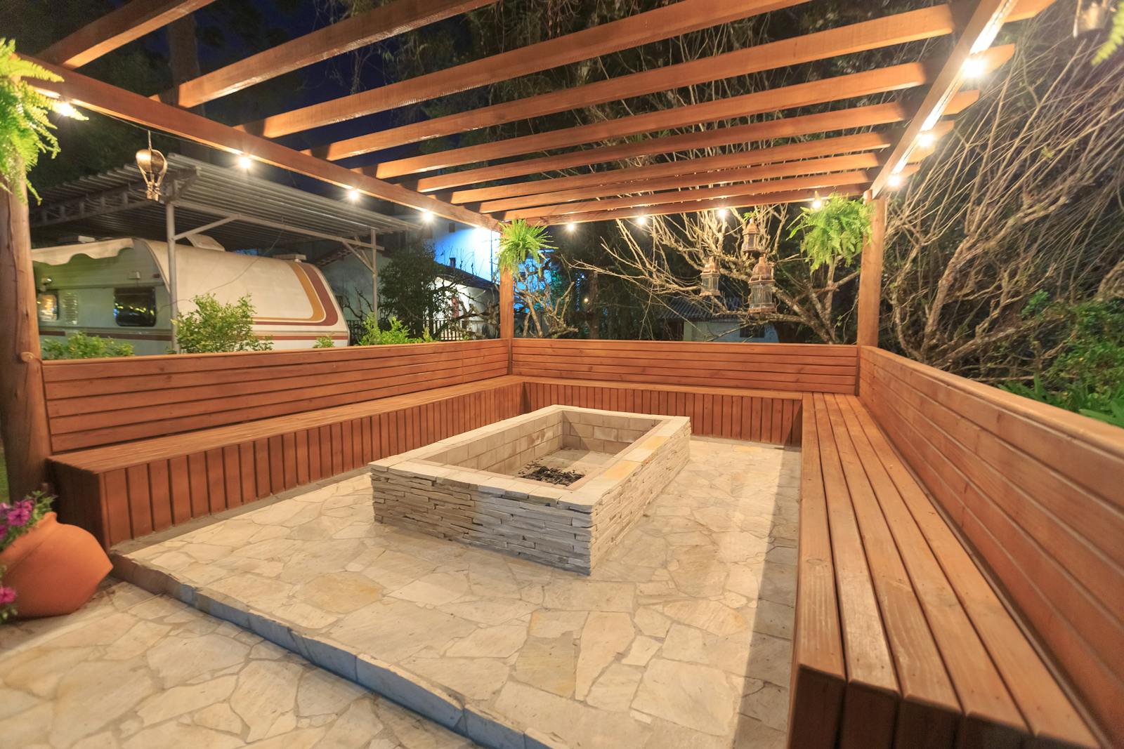 Cozy backyard entertaining space with patio, fire pit and lighting