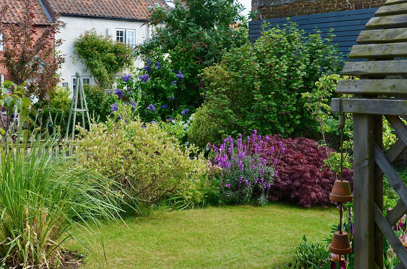 Lush, layered cottage-style planting full of color and texture