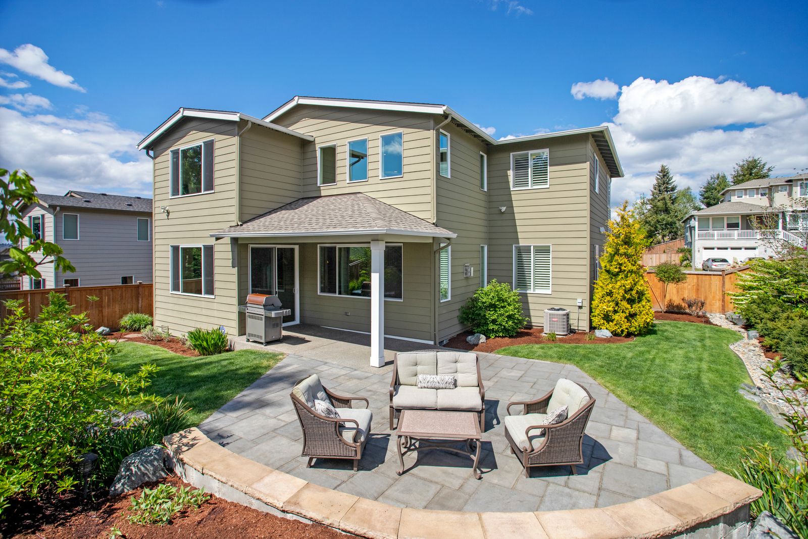 A paver patio in a landscaped backyard