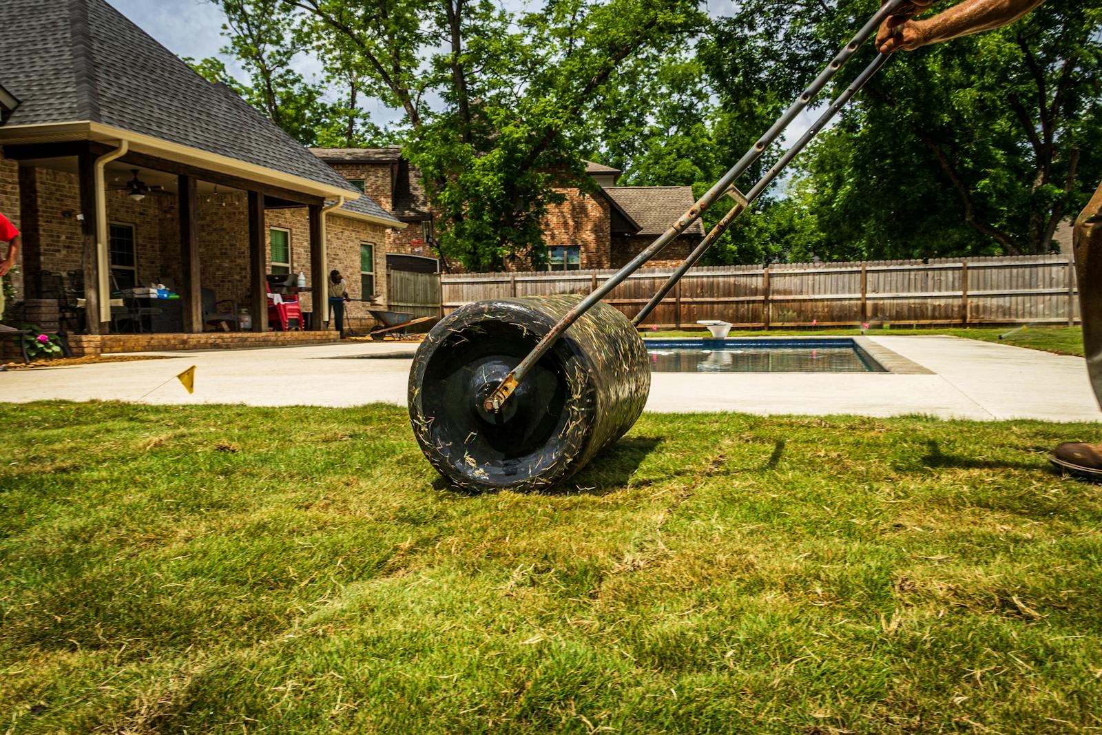 Fresh sod being laid on a prepared lawn